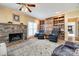 Cozy living room featuring a stone fireplace, built-in bookshelves, and hardwood floors at 1515 Paul Boyd Rd, Clover, SC 29710