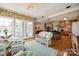 Open concept living space seamlessly connects the sunroom and kitchen, featuring stylish decor and bar seating at 1515 Paul Boyd Rd, Clover, SC 29710