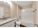 This bathroom offers a shower-tub combo, granite countertop on the vanity, and wood-look flooring at 1587 Green Circle Dr, Gastonia, NC 28054