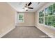 This bright bedroom is adorned with neutral walls, plush carpeting, and two large windows offering ample natural light at 1587 Green Circle Dr, Gastonia, NC 28054