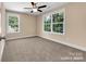 This expansive bedroom is well-lit with neutral walls, plush carpeting, and two large windows offering ample natural light at 1587 Green Circle Dr, Gastonia, NC 28054