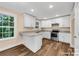 New kitchen with stainless appliances, an island with a sink, granite countertops, and custom white cabinets at 1587 Green Circle Dr, Gastonia, NC 28054