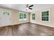 Inviting living room featuring wood-look floors and ample natural light from multiple windows at 1587 Green Circle Dr, Gastonia, NC 28054