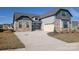 Beautiful new construction home with stone accents and a two-car garage, with a wide driveway and a manicured lawn at 1925 Hendricks St, Rock Hill, SC 29732