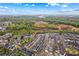 An aerial view showing the home's location relative to the greenbelt, nearby shopping, and the lake in the distance at 19737 Playwrights Way, Cornelius, NC 28031