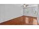Bright bedroom featuring hardwood floors and ample natural light from two windows at 19737 Playwrights Way, Cornelius, NC 28031