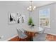 Staged dining area with hardwood floors, chandelier, and window at 19737 Playwrights Way, Cornelius, NC 28031