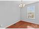 Dining area with chandelier, hardwood floors, and window at 19737 Playwrights Way, Cornelius, NC 28031
