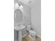 Clean and simple half bathroom featuring a pedestal sink and toilet at 19737 Playwrights Way, Cornelius, NC 28031