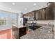 Kitchen with stainless appliances, island, granite countertops, and wood floors at 19737 Playwrights Way, Cornelius, NC 28031