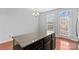 Kitchen island with granite countertops, wood floors, and natural light at 19737 Playwrights Way, Cornelius, NC 28031
