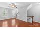 Well-lit living area with hardwood floors, staircase, and large windows for natural light at 19737 Playwrights Way, Cornelius, NC 28031