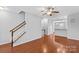 Open-concept living room with hardwood floors and staircase at 19737 Playwrights Way, Cornelius, NC 28031