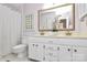 Bright bathroom featuring a double vanity with white cabinets, gold fixtures, and classic toilet at 201 Riverview Ter, Lake Wylie, SC 29710