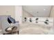 Bright loft features custom built-in shelving and accent chair over neutral carpeting at 201 Riverview Ter, Lake Wylie, SC 29710