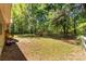 Lush backyard featuring a wooden playset and a wood fence, ideal for Gathering fun and relaxation at 2014 Cardinal Loop, Stanley, NC 28164