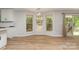 Open dining area with wood floors, windows, and a modern chandelier fixture at 2014 Cardinal Loop, Stanley, NC 28164