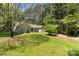 Beautiful home nestled on a spacious lot with mature trees and lush greenery, offering privacy and tranquility at 2014 Cardinal Loop, Stanley, NC 28164
