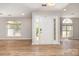 Bright foyer featuring a front door with side windows and wood-look flooring, creating an inviting entrance at 2014 Cardinal Loop, Stanley, NC 28164