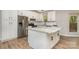 This kitchen has white cabinets, granite countertops, stainless steel appliances, and a large kitchen island at 2014 Cardinal Loop, Stanley, NC 28164