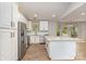 Bright kitchen with white cabinets, granite countertops, stainless steel appliances, and a large island with seating at 2014 Cardinal Loop, Stanley, NC 28164