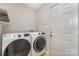 Convenient laundry room featuring modern washer and dryer units and a shelf for storage at 2014 Cardinal Loop, Stanley, NC 28164