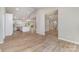 Open-concept living space featuring wood-look flooring, a vaulted ceiling, and a seamless flow, perfect for gatherings at 2014 Cardinal Loop, Stanley, NC 28164