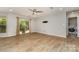 The living room has wood floors, a ceiling fan, and sliding doors with easy access to the laundry room at 2014 Cardinal Loop, Stanley, NC 28164