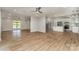 Spacious living room with wood floors seamlessly connects to the kitchen with a large island and stainless steel appliances at 2014 Cardinal Loop, Stanley, NC 28164