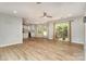 Bright living room featuring wood floors, ceiling fan, and sliding glass doors leading to the backyard with a playhouse at 2014 Cardinal Loop, Stanley, NC 28164