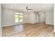 Bright and airy living room featuring wood-look flooring, ceiling fan, and large windows, perfect for relaxation at 2014 Cardinal Loop, Stanley, NC 28164