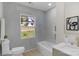 Serene bathroom featuring a soaking tub, tile surround, and modern vanity at 215 Wyanoke Ave, Charlotte, NC 28205