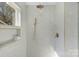 Modern shower with a rainfall shower head, hand held sprayer, and custom tile at 215 Wyanoke Ave, Charlotte, NC 28205