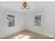 Well-lit bedroom with hardwood floors and two windows providing natural light at 215 Wyanoke Ave, Charlotte, NC 28205