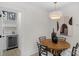 Cozy dining area featuring a round table, stylish chairs, and a convenient wet bar with a mini-fridge at 215 Wyanoke Ave, Charlotte, NC 28205