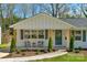 Inviting front porch with stylish seating area, decorative plants, and attractive architectural details at 215 Wyanoke Ave, Charlotte, NC 28205