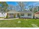 Charming single-story home with a well-manicured lawn, inviting curb appeal, and beautiful landscaping at 215 Wyanoke Ave, Charlotte, NC 28205