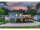 View of a back exterior featuring a large deck, patio and ample parking space at 215 Wyanoke Ave, Charlotte, NC 28205