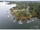 An aerial view of private boat docks, a waterfront neighborhood, and open water at 2587 Penngate Dr, Sherrills Ford, NC 28673