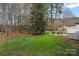 A lush green backyard featuring an outdoor seating area and beautiful mature trees around the home at 2587 Penngate Dr, Sherrills Ford, NC 28673