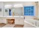 Bright bathroom with a dual sink vanity, a makeup counter, a soaking tub and lots of natural light at 2587 Penngate Dr, Sherrills Ford, NC 28673