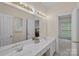 Bright bathroom with double vanity, ample lighting and neutral color palette at 2587 Penngate Dr, Sherrills Ford, NC 28673