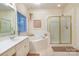 Bright bathroom featuring a walk-in shower, soaking tub, tiled floor, and a vanity sink next to a window at 2587 Penngate Dr, Sherrills Ford, NC 28673