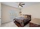 Cozy bedroom featuring a large window, dark wood trim, and a ceiling fan at 2587 Penngate Dr, Sherrills Ford, NC 28673