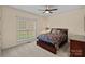 Bedroom with dark wood trim, bright window, neutral color palette, and standard closet at 2587 Penngate Dr, Sherrills Ford, NC 28673