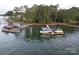 Lake view of boat docks with covered boats along the waterfront near a wooded shoreline at 2587 Penngate Dr, Sherrills Ford, NC 28673
