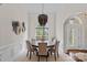 Traditional dining room with a decorative chandelier, arched window, and wainscoting detail at 2587 Penngate Dr, Sherrills Ford, NC 28673