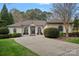 Charming home with arched windows, neutral stucco and meticulously maintained front yard landscaping at 2587 Penngate Dr, Sherrills Ford, NC 28673