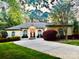 Elegant single-story home with a circular driveway, manicured landscaping, and arched windows at 2587 Penngate Dr, Sherrills Ford, NC 28673