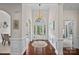 Elegant foyer with hardwood floors, wainscoting detail, statement chandelier, and lots of natural light at 2587 Penngate Dr, Sherrills Ford, NC 28673